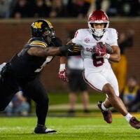 Nov 9, 2024; Columbia, Missouri, USA; Oklahoma Sooners running back Taylor Tatum (8) runs the ball against Missouri Tigers defensive tackle Kristian Williams (5) during the first half at Faurot Field at Memorial Stadium.