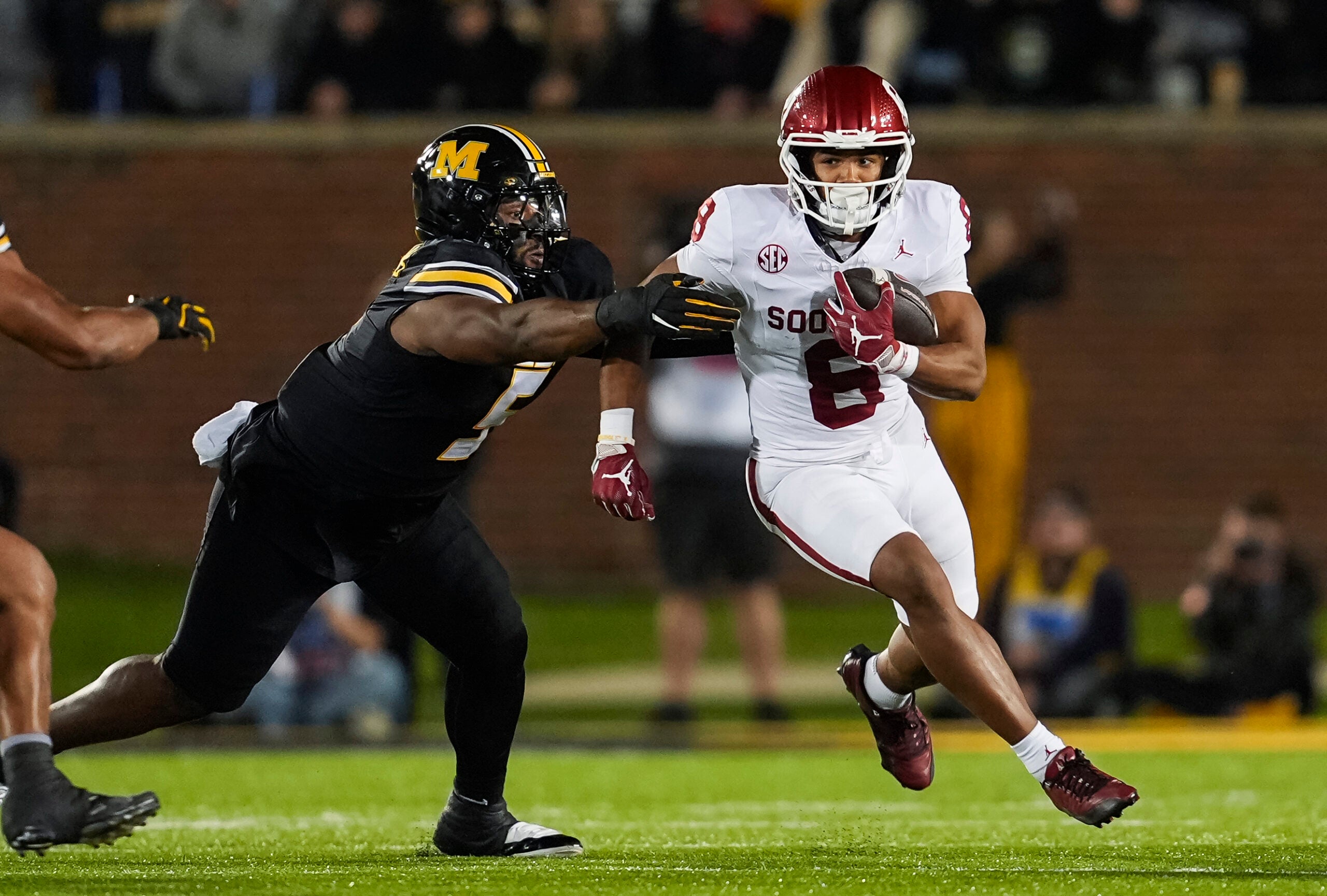 Nov 9, 2024; Columbia, Missouri, USA; Oklahoma Sooners running back Taylor Tatum (8) runs the ball against Missouri Tigers defensive tackle Kristian Williams (5) during the first half at Faurot Field at Memorial Stadium.