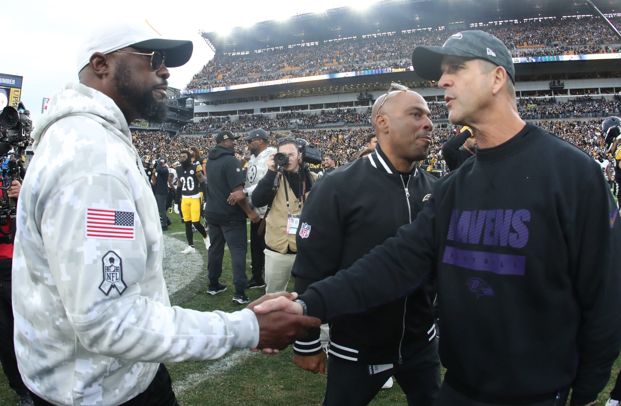 Nov 17, 2024; Pittsburgh, Pennsylvania, USA; Pittsburgh Steelers head coach Mike Tomlin (left) and Baltimore Ravens head coach John Harbaugh (right) shake hands after the game at Acrisure Stadium.