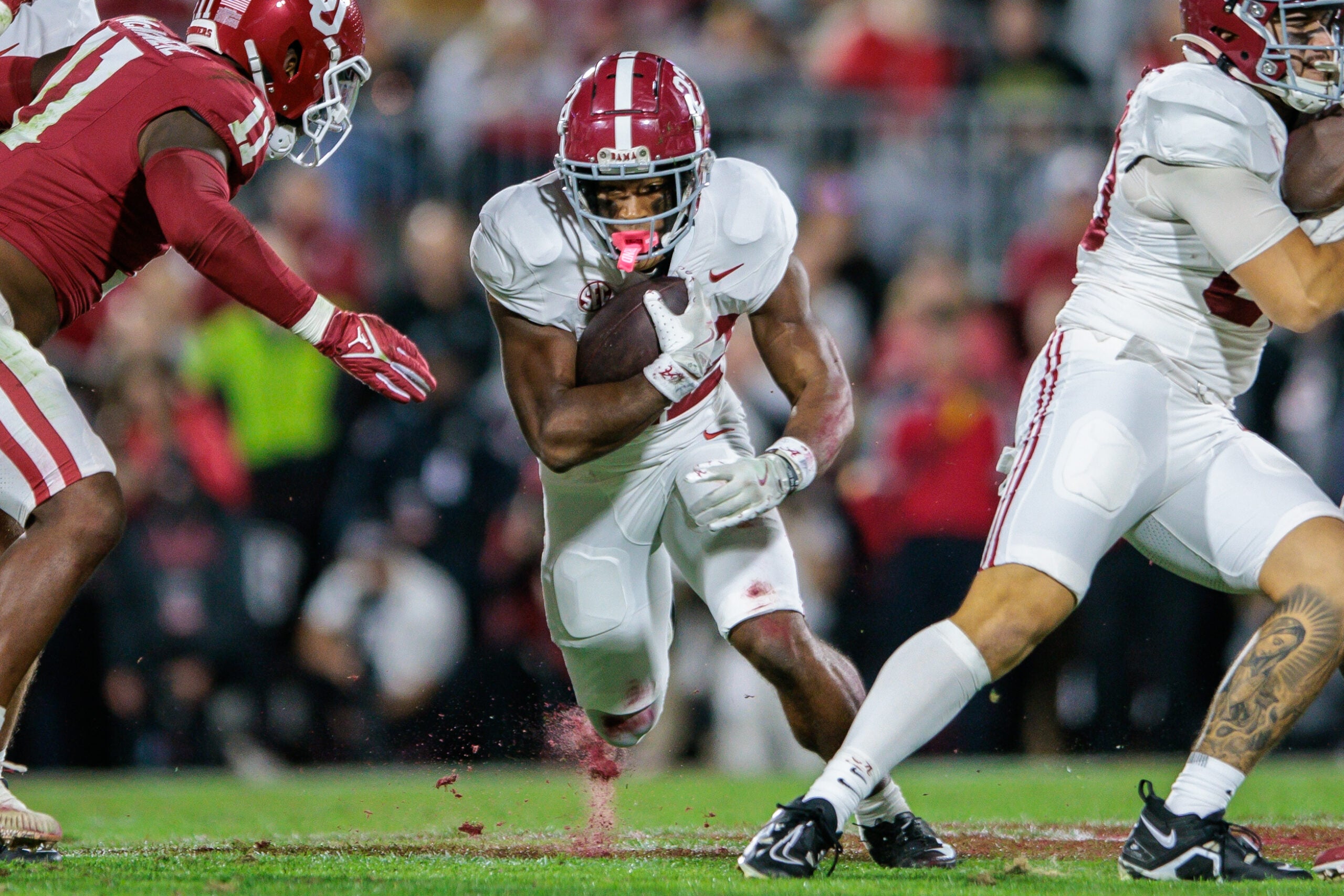 Nov 23, 2024; Norman, Oklahoma, USA; Alabama Crimson Tide running back Justice Haynes (22) runs the ball during the second quarter against the Oklahoma Sooners at Gaylord Family-Oklahoma Memorial Stadium.