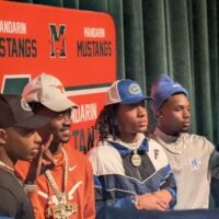 Mandarin quarterback Tramell Jones Jr. (Florida), wide receiver Jaime Ffrench Jr. (Texas), safety Hylton (Drake) Stubbs (Florida) and defensive back Jaylen Lewis (Memphis) celebrate their college football signings on Dec. 4, 2024.