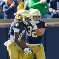 Apr 12, 2025; Notre Dame, IN, USA; Notre Dame Fighting Irish tight end Justin Fisher (32) celebrates with Notre Dame Fighting Irish wide receiver Scrap Richardson (81) after he scored a touchdown during the Blue-Gold game at Notre Dame Stadium. Mandatory Credit: Michael Caterina-Imagn Images