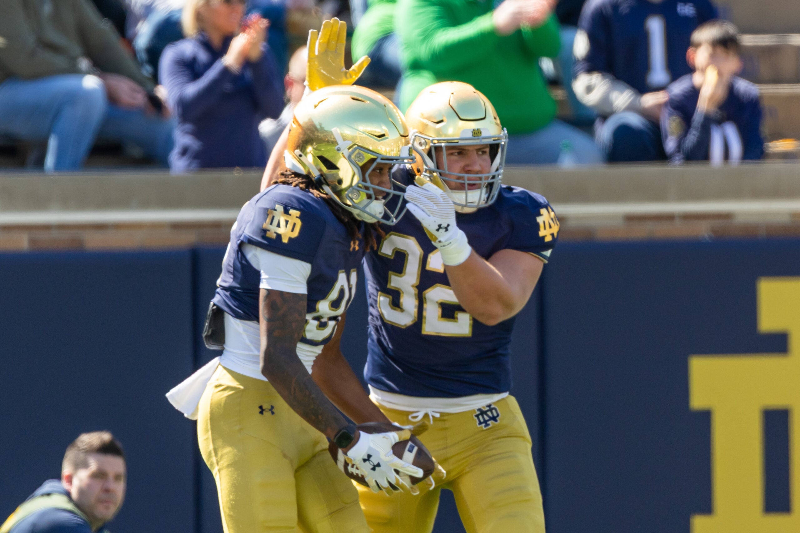 Apr 12, 2025; Notre Dame, IN, USA; Notre Dame Fighting Irish tight end Justin Fisher (32) celebrates with Notre Dame Fighting Irish wide receiver Scrap Richardson (81) after he scored a touchdown during the Blue-Gold game at Notre Dame Stadium. Mandatory Credit: Michael Caterina-Imagn Images
