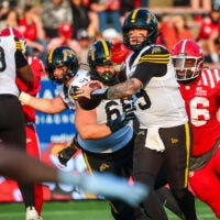 Jun 7, 2025; Calgary, Alberta, Canada; Hamilton Tiger-Cats quarterback Bo Levi Mitchell (19) looks to pass against the Calgary Stampeders during the second half at McMahon Stadium.