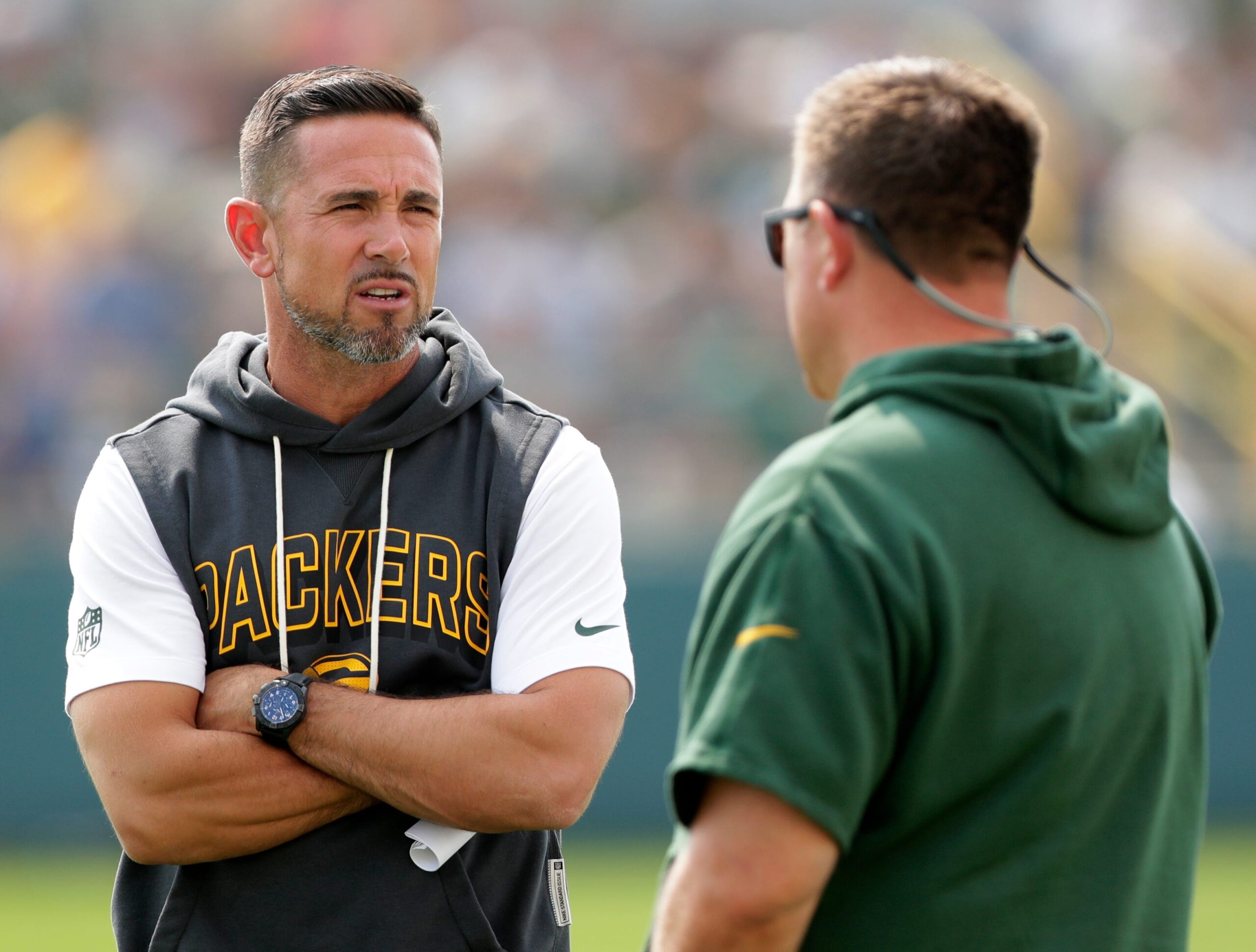 Green Bay Packers Coach Matt LaFleur, left, talks with General Manager Brian Gutekunst during practice on July 25, 2025, at Ray Nitschke Field in Ashwaubenon, Wis.