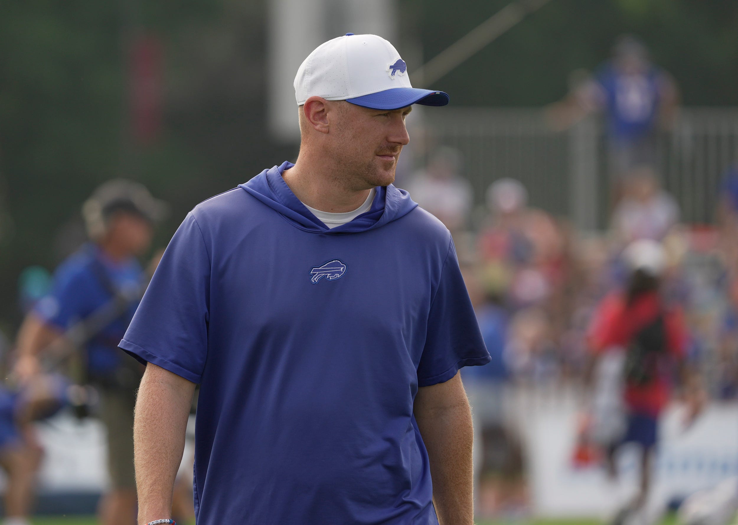 Buffalo Bills offensive coordinator Joe Brady walks around the field looking over the team as they stretch before Bills Training Camp at St. John Fisher University in Pittsford on Aug.6, 2025.