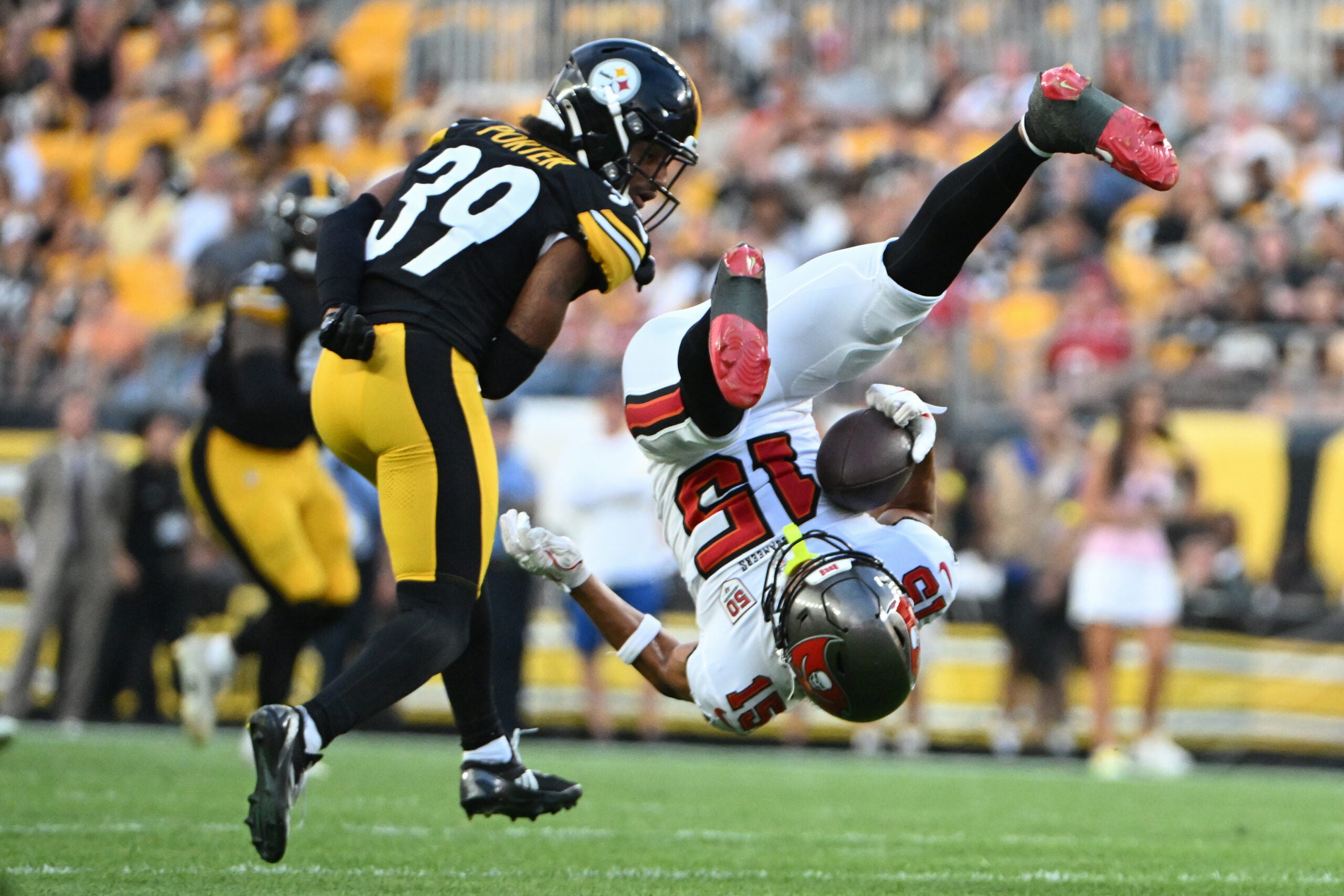 Aug 16, 2025; Pittsburgh, Pennsylvania, USA; Tampa Bay Buccaneers wide receiver Jalen McMillan (15) makes a catch against Pittsburgh Steelers cornerback Daryl Porter Jr. (39) during the first quarter at Acrisure Stadium.