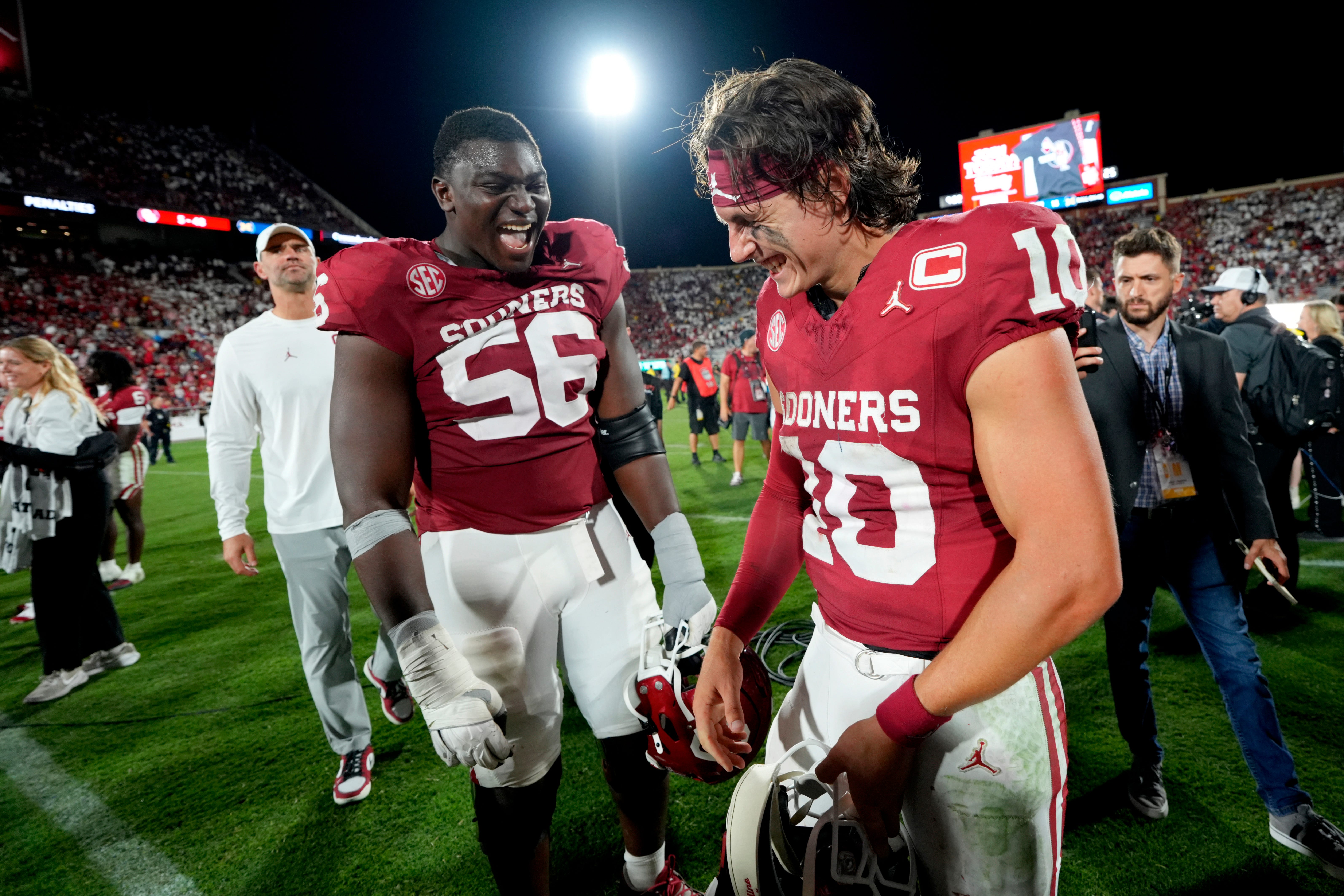 Oklahoma Sooners quarterback John Mateer (10) and offensive lineman Michael Fasusi (56) celebrate after a college football game between the University of Oklahoma Sooners (OU) and the University of Michigan Wolverines at Gaylord Family Ð Oklahoma Memorial Stadium in Norman, Okla., Saturday, Sept. 6, 2025. Oklahoma won 24-13.