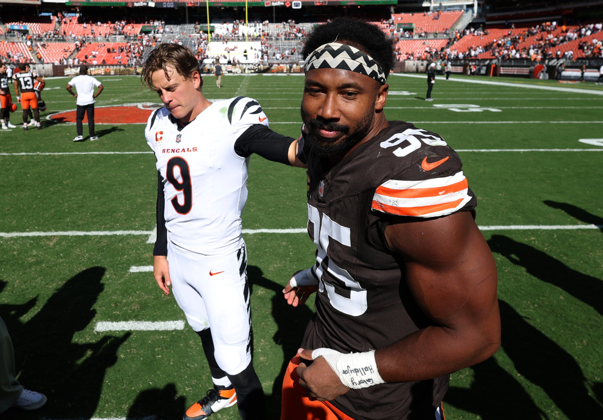 Sep 7, 2025; Cleveland, Ohio, USA; Cincinnati Bengals quarterback Joe Burrow (9) and Cleveland Browns defensive end Myles Garrett (95) greet each other after a game at Huntington Bank Field.