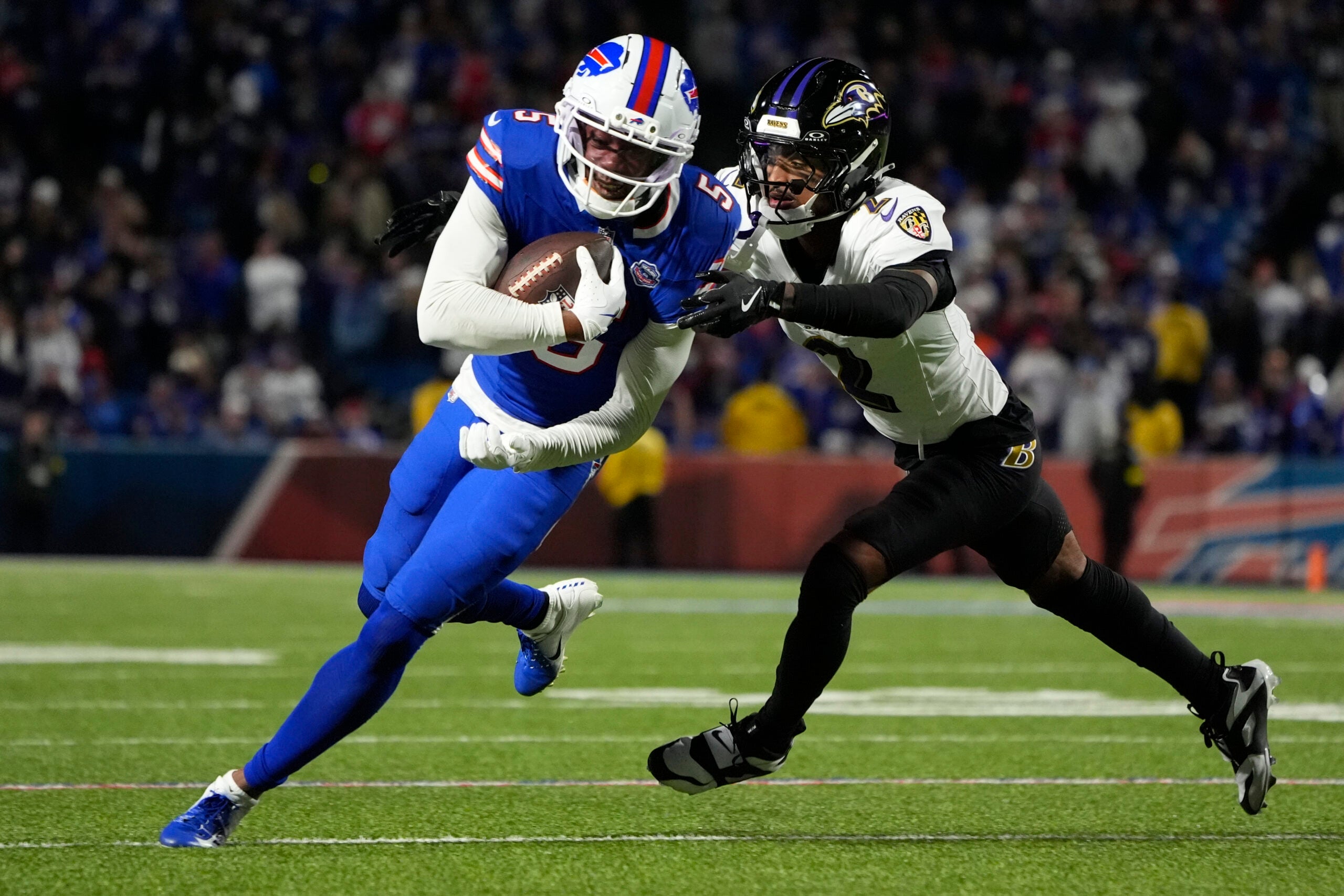 Sep 7, 2025; Orchard Park, New York, USA; Buffalo Bills wide receiver Joshua Palmer (5) runs the ball against Baltimore Ravens cornerback Nate Wiggins (2) during the fourth quarter at Highmark Stadium.