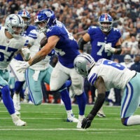 Sep 14, 2025; Arlington, Texas, USA; New York Giants running back Cam Skattebo (44) runs with the ball against Dallas Cowboys linebacker Jack Sanborn (57) during the fourth quarter at AT&T Stadium.