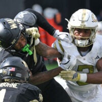 Sep 27, 2025; Winston-Salem, North Carolina, USA; Wake Forest Demon Deacons wide receiver Micah Mays Jr. (7) takes a hit from Georgia Tech Yellow Jackets defensive back Ahmari Harvey (3) during the third quarter at Allegacy Federal Credit Union Stadium.