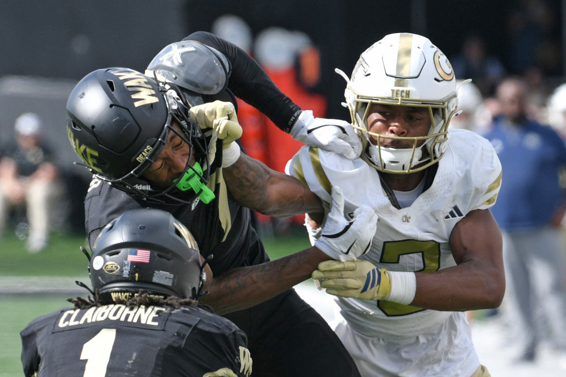 Sep 27, 2025; Winston-Salem, North Carolina, USA; Wake Forest Demon Deacons wide receiver Micah Mays Jr. (7) takes a hit from Georgia Tech Yellow Jackets defensive back Ahmari Harvey (3) during the third quarter at Allegacy Federal Credit Union Stadium.