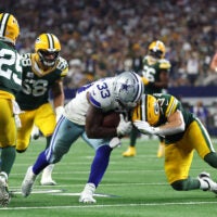 Sep 28, 2025; Arlington, Texas, USA; Dallas Cowboys running back Javonte Williams (33) runs for a touchdown against the Green Bay Packers in the fourth quarter at AT&T Stadium.