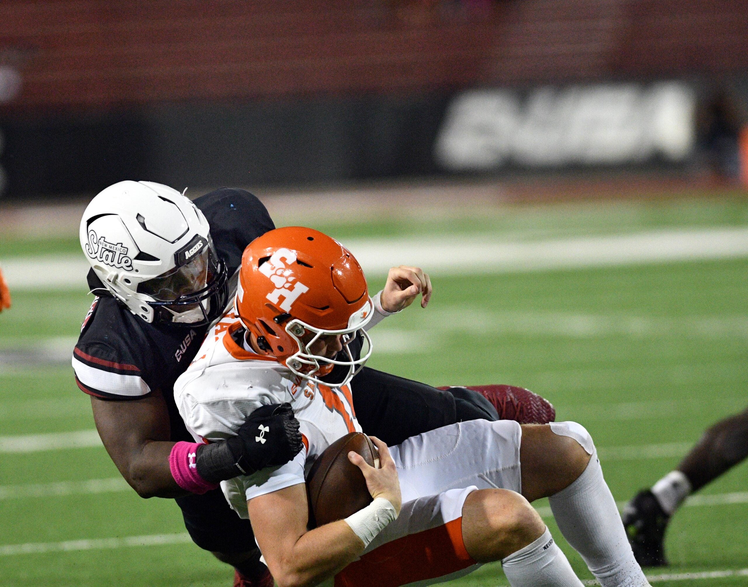 Aggie defensive lineman Ezra Christensen tackles the Bearkat quarterback for loss during Thursday night game against Sam Houston State at Aggie Memorial.