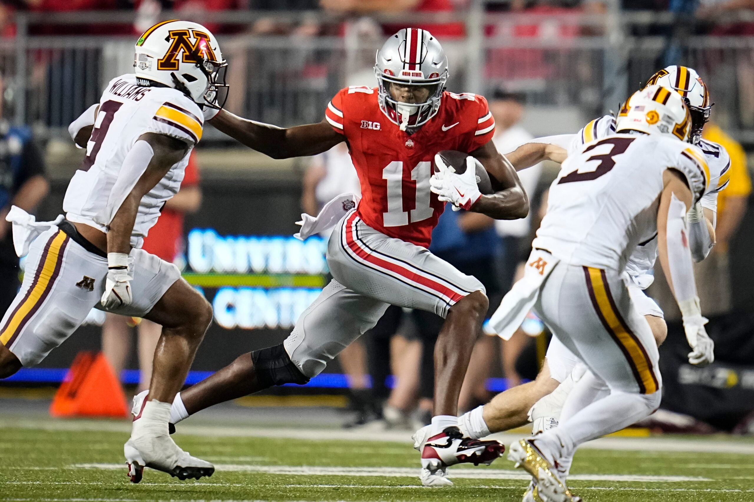 Ohio State Buckeyes wide receiver Quincy Porter (11) runs past Minnesota Golden Gophers linebacker Devon Williams (9) during the NCAA football game at Ohio Stadium in Columbus on Oct. 4, 2025. Ohio State won 42-3.