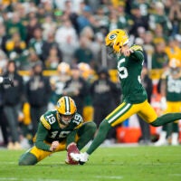 Oct 12, 2025; Green Bay, Wisconsin, USA; Green Bay Packers kicker Lucas Havrisik (35) kicks a field goal with punter Daniel Whelan (19) in the fourth quarter against the Cincinnati Bengals at Lambeau Field.