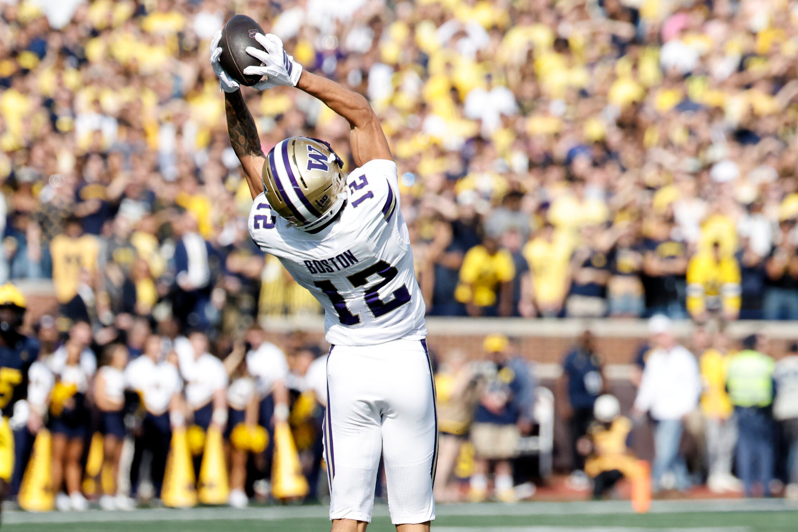 Oct 18, 2025; Ann Arbor, Michigan, USA; Washington Huskies wide receiver Denzel Boston (12) makes a reception in the first half against the Michigan Wolverines at Michigan Stadium.