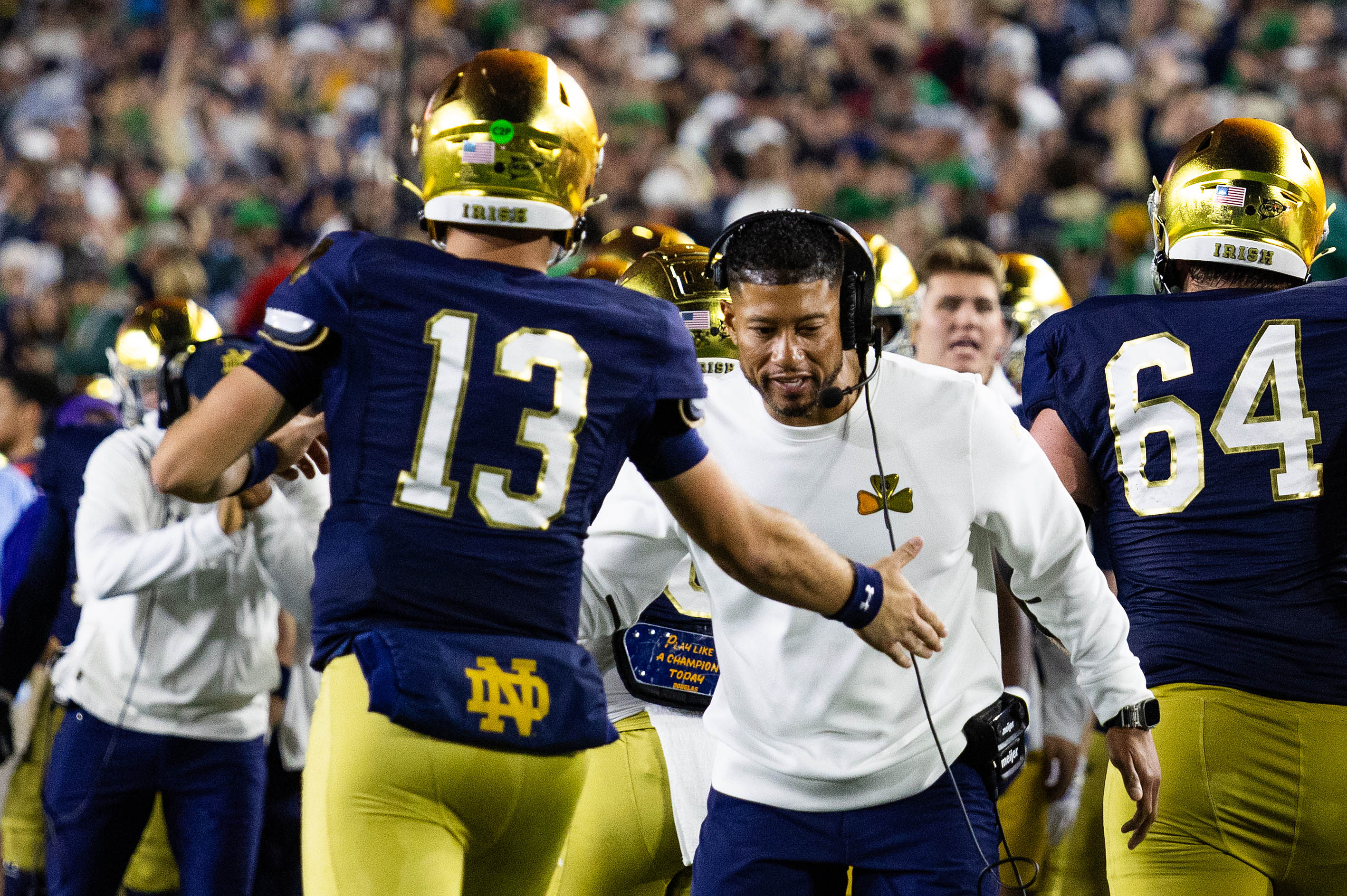 Oct 18, 2025; South Bend, Indiana, USA; Notre Dame Fighting Irish head coach Marcus Freeman celebrates with quarterback CJ Carr (13) in the first half against the Southern California Trojans at Notre Dame Stadium. Mandatory Credit: Trevor Ruszkowski-Imagn Images
