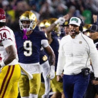 Oct 18, 2025; South Bend, Indiana, USA; Notre Dame Fighting Irish head coach Marcus Freeman and the defense celebrates a turnover on downs in second half against the Southern California Trojans at Notre Dame Stadium. Mandatory Credit: Trevor Ruszkowski-Imagn Images