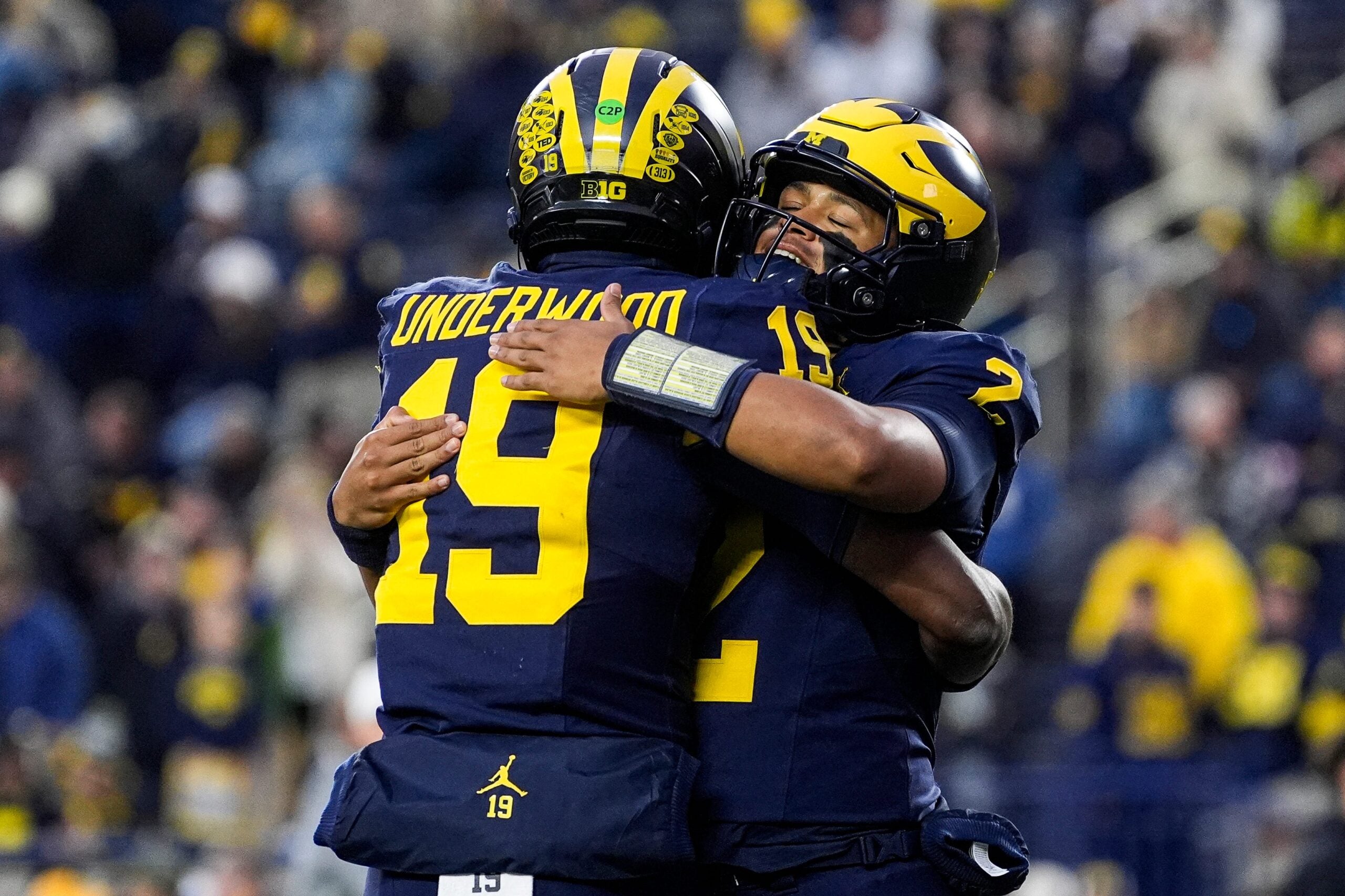 Michigan quarterback Bryce Underwood (19) hugs quarterback Jadyn Davis (2) during warm up ahead of the Purdue game at Michigan Stadium in Ann Arbor on Saturday, November 1, 2025.
