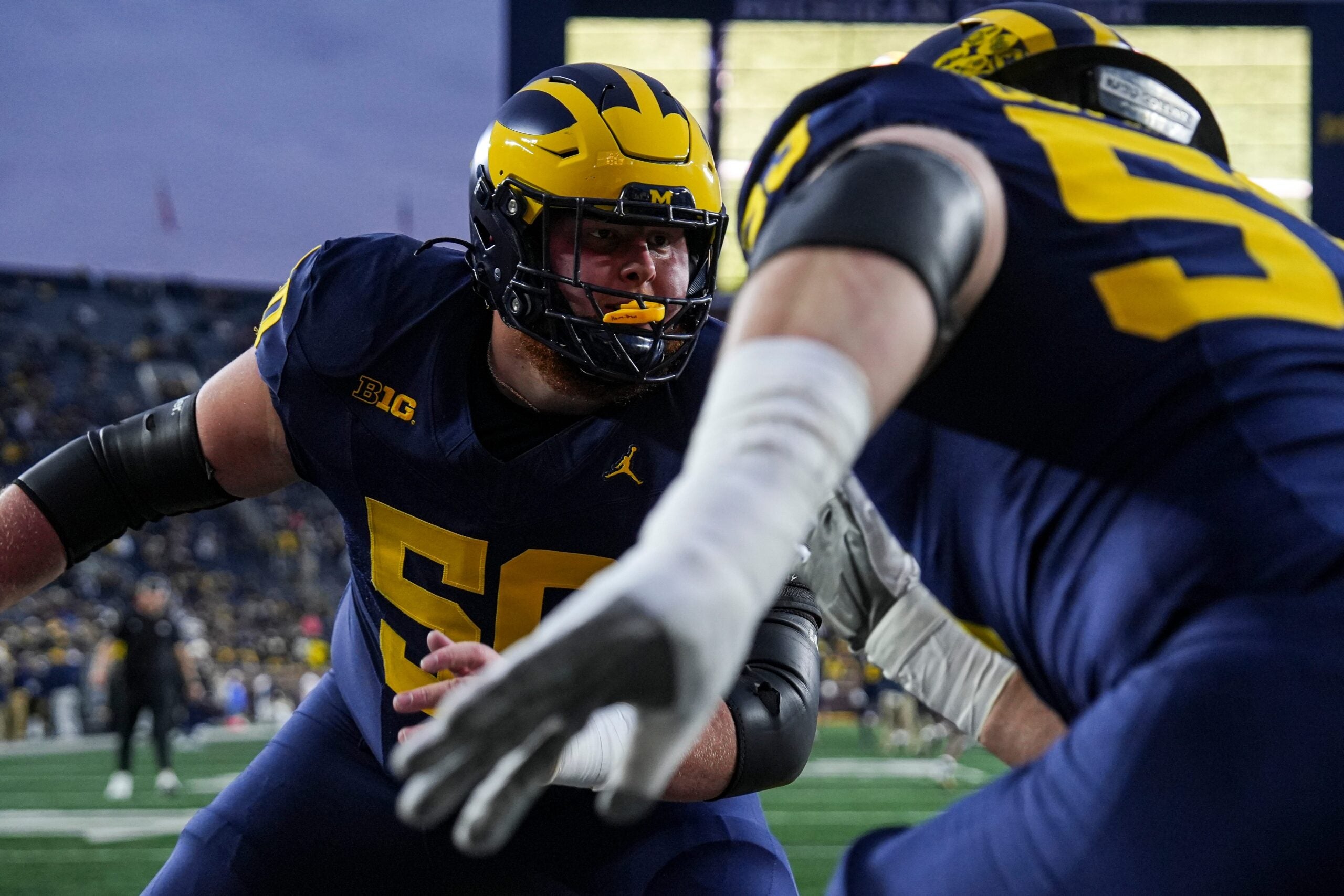 Michigan offensive lineman Luke Hamilton (50) warms up with offensive lineman Jake Guarnera (53) ahead of the Purdue game at Michigan Stadium in Ann Arbor on Saturday, November 1, 2025.