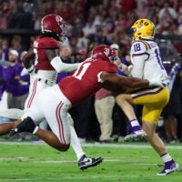 Nov 8, 2025; Tuscaloosa, Alabama, USA; Louisiana State Tigers quarterback Garrett Nussmeier (18) under pressure from Alabama Crimson Tide linebacker Deontae Lawson (0) and defensive lineman Keon Keeley (31) during the second quarter of the game at Saban Field at Bryant-Denny Stadium. Mandatory Credit: David Leong-Imagn Images