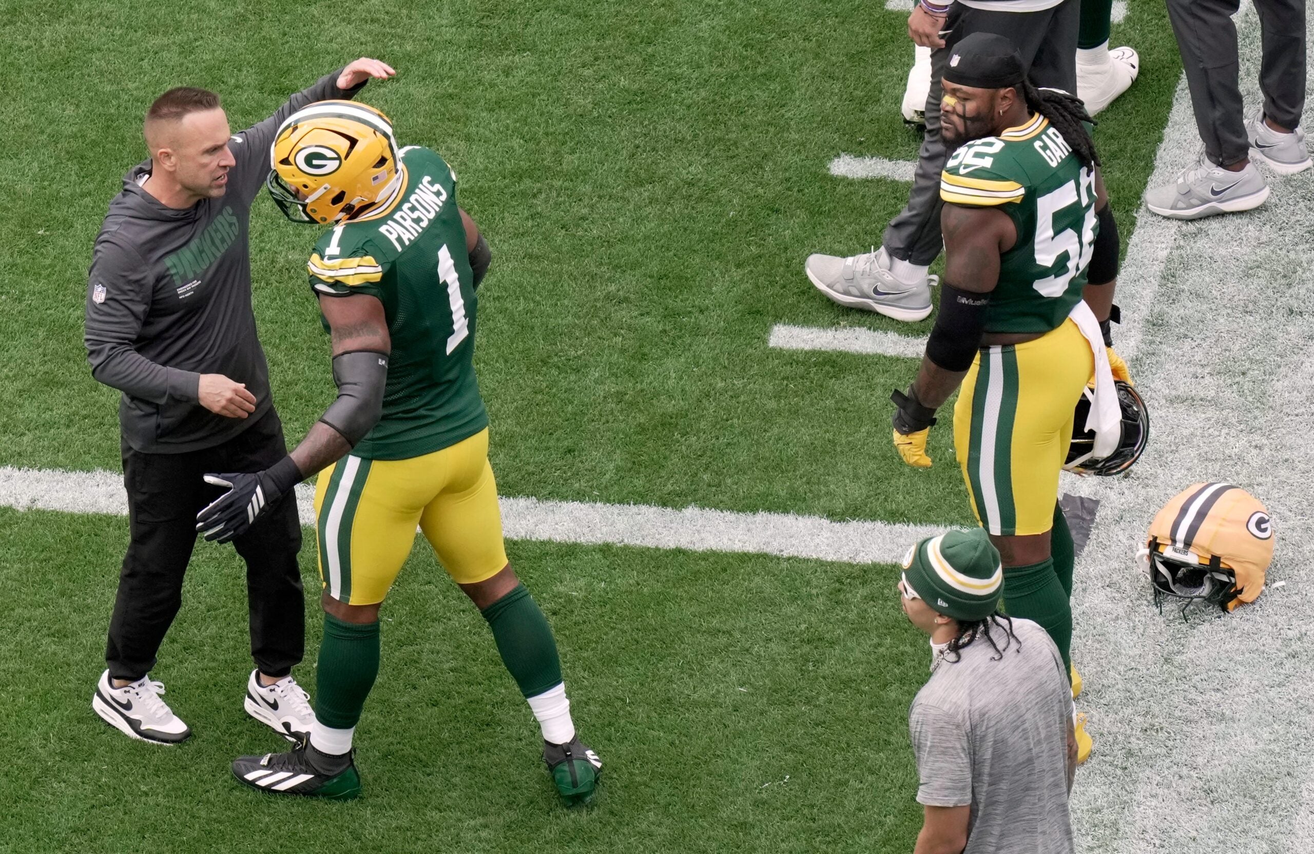Green Bay Packers defensive coordinator Jeff Hafley hugs defensive end Micah Parsons (1) as defensive end Rashan Gary (52) looks on before their game against the Detroit Lions Sunday, September 7, 2025 at Lambeau Field in Green Bay, Wisconsin.