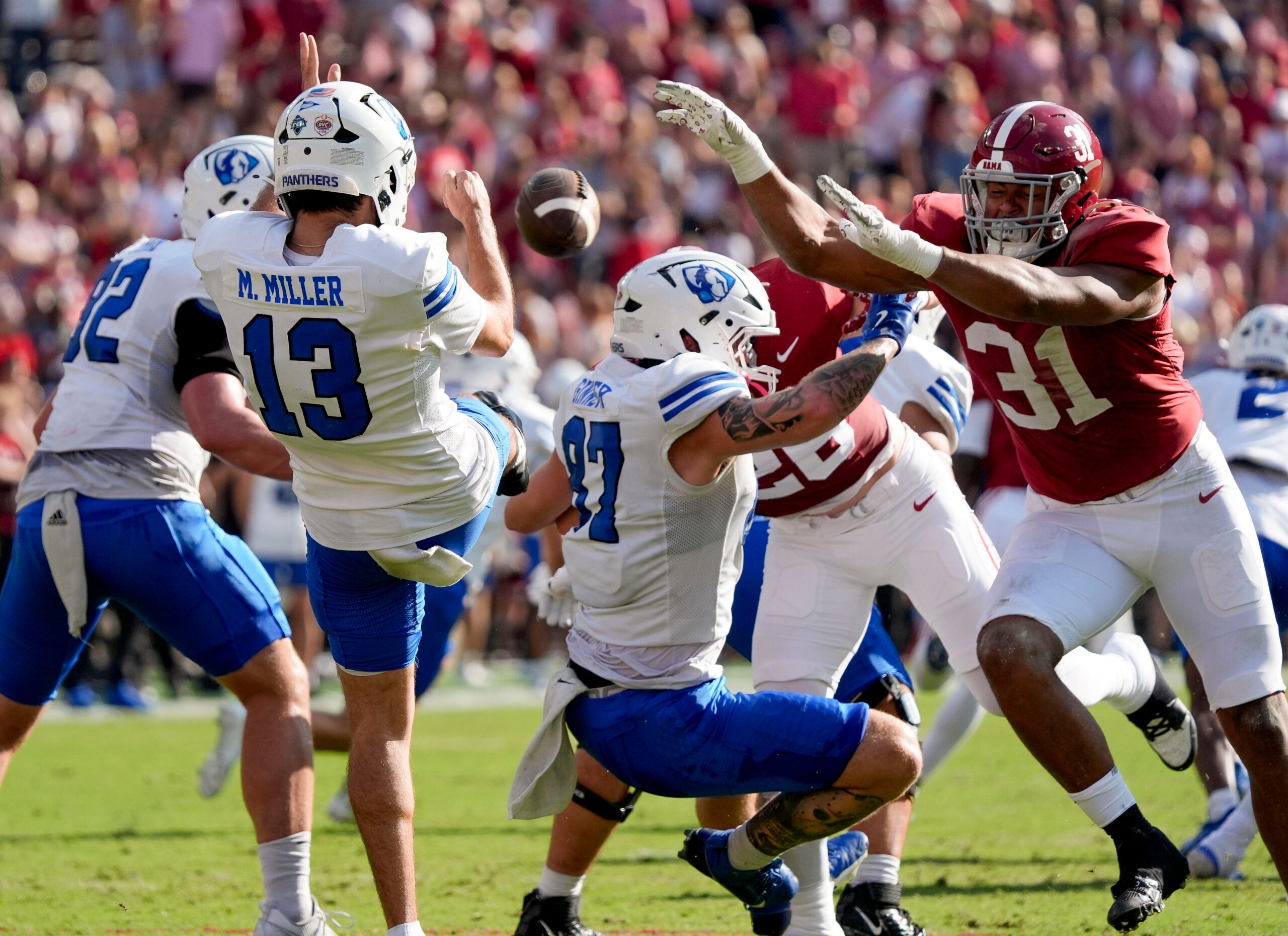 Nov 22, 2025; Tuscaloosa, Alabama, USA; Alabama defensive lineman Keon Keeley (31) blocks a punt by Eastern Illinois punter Mason Miller (13) at Saban Field at Bryant-Denny Stadium. Mandatory Credit: Gary Cosby Jr.-Imagn Images