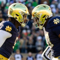 Nov 22, 2025; South Bend, Indiana, USA; Notre Dame Fighting Irish defensive lineman Boubacar Traore, left, and Notre Dame Fighting Irish defensive lineman Jason Onye, right celebrate a stop against the Syracuse Orange during the first half at Notre Dame Stadium. Mandatory Credit: Michael Caterina-Imagn Images