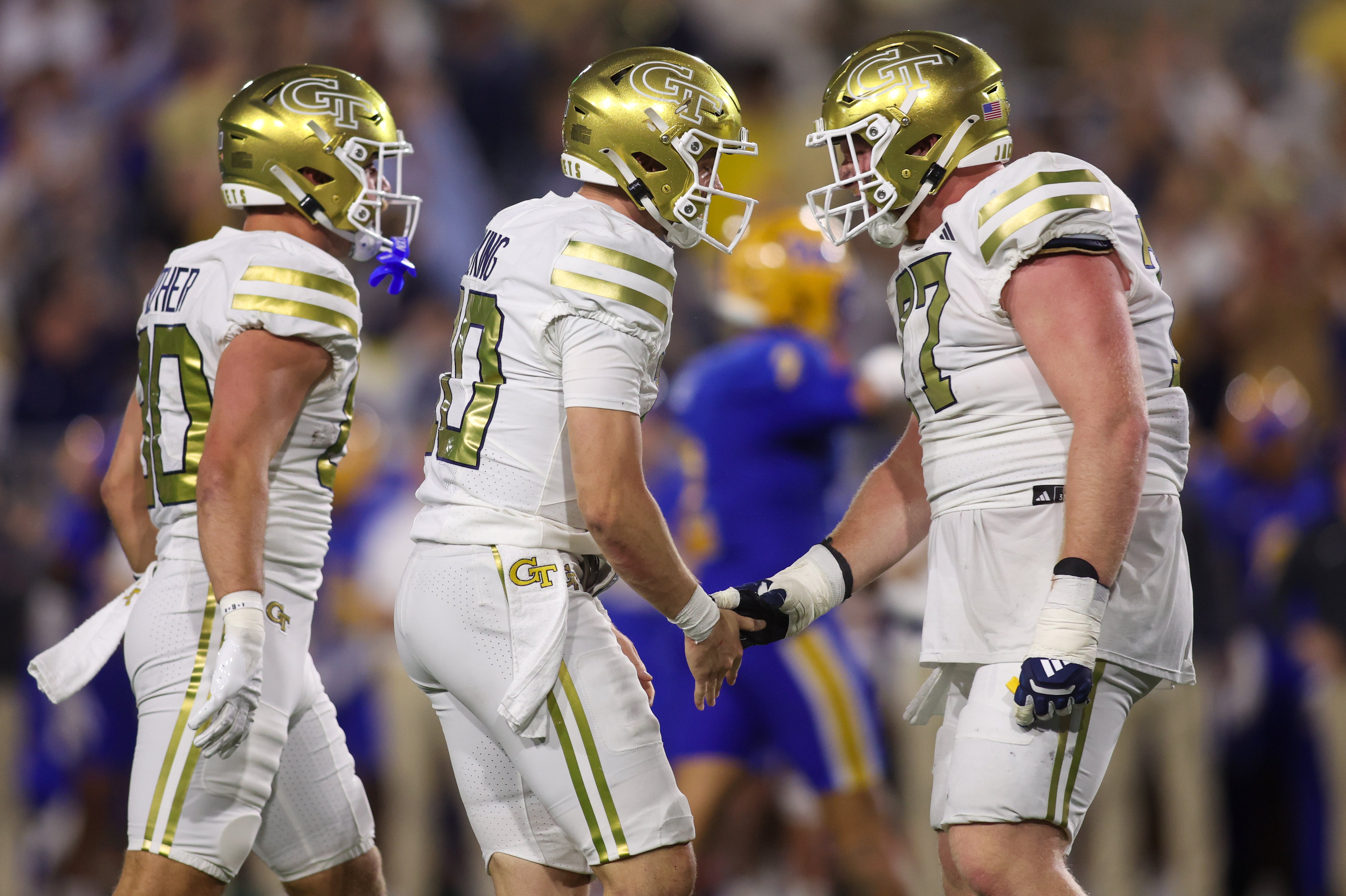 Nov 22, 2025; Atlanta, Georgia, USA; Georgia Tech Yellow Jackets quarterback Haynes King (10) celebrates with offensive lineman Keylan Rutledge (77) after a touchdown pass against the Pittsburgh Panthers in the second quarter at Bobby Dodd Stadium at Hyundai Field.