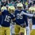 Nov 22, 2025; South Bend, Indiana, USA; Notre Dame Fighting Irish cornerback Leonard Moore (15) celebrates with defensive lineman Bryce Young (95) and cornerback Christian Gray (6) after scoring against the Syracuse Orange during the first half at Notre Dame Stadium. Mandatory Credit: Michael Caterina-Imagn Images