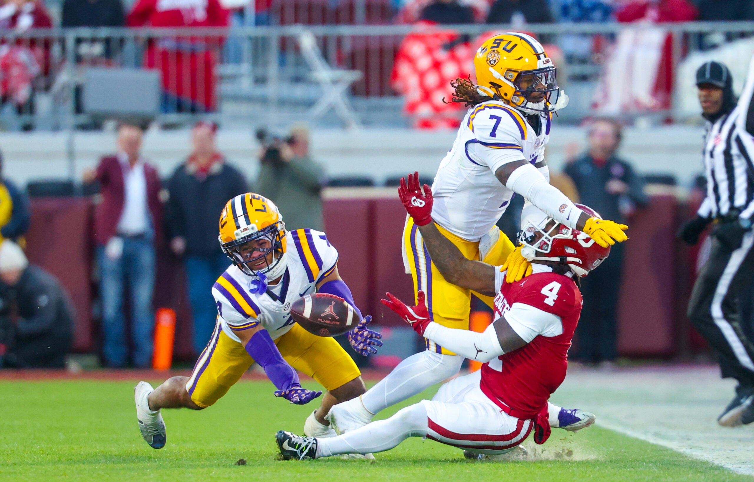 Nov 29, 2025; Norman, Oklahoma, USA; Louisiana State Tigers linebacker Harold Perkins Jr. (7) and Louisiana State Tigers cornerback Mansoor Delane (4) defend a pass intended for Oklahoma Sooners wide receiver Deion Burks (4) during the game at Gaylord Family-Oklahoma Memorial Stadium. Mandatory Credit: Kevin Jairaj-Imagn Images