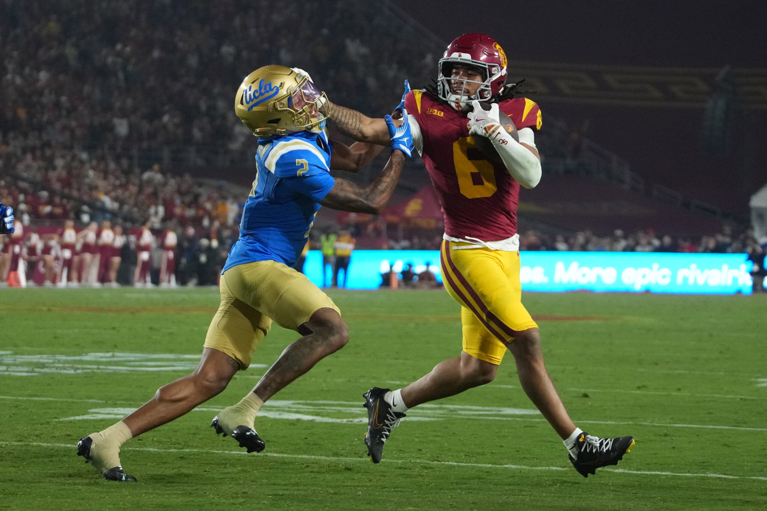 Nov 29, 2025; Los Angeles, California, USA; Southern California Trojans wide receiver Makai Lemon (6) carries the ball against UCLA Bruins defensive back Andre Jordan Jr. (2) in the second half at United Airlines Field at Los Angeles Memorial Coliseum. Mandatory Credit: Kirby Lee-Imagn Images
