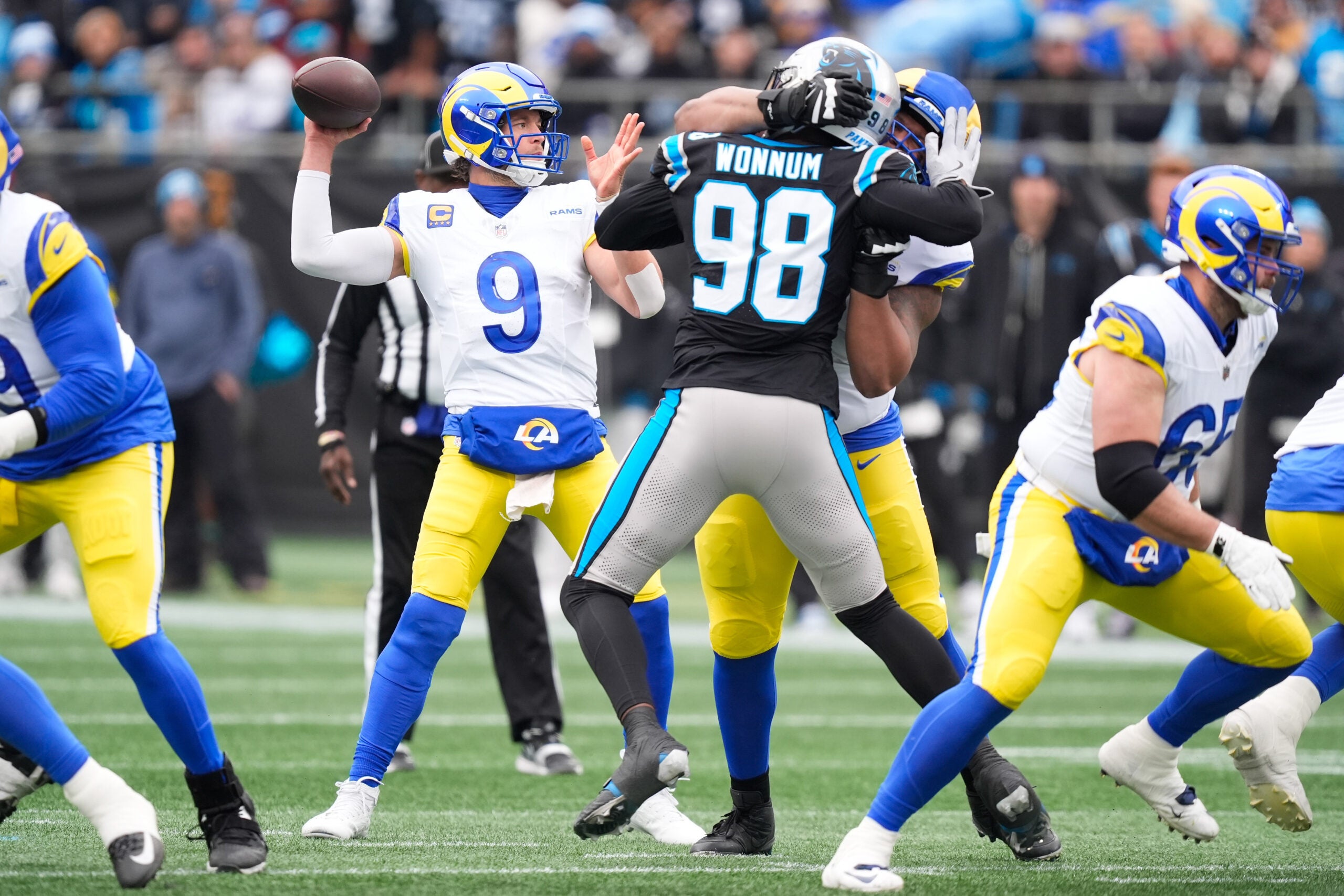 Nov 30, 2025; Charlotte, North Carolina, USA; Los Angeles Rams quarterback Matthew Stafford (9) throws a pass during the first quarter against the Carolina Panthers at Bank of America Stadium.