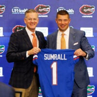 Dec 1, 2025; Gainesville, FL, USA; Florida Gators athletic director Scott Stricklin and Florida Gators head coach Jon Sumrall poses with a Florida Gators jersey during the press conference at the Heavener Football Training Center at the University of Florida.