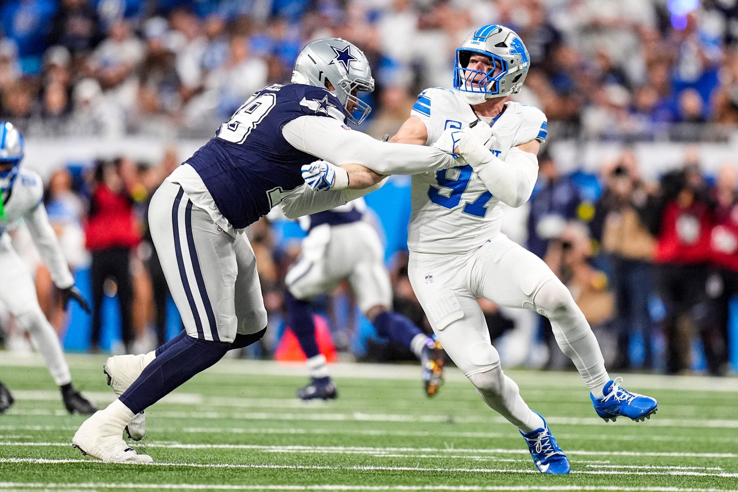 Detroit Lions defensive end Aidan Hutchinson (97) pressures Dallas Cowboys offensive tackle Terence Steele (78) during the first half at Ford Field in Detroit on Thursday, Dec. 4, 2025.