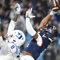 Dec 6, 2025; Charlotte, NC, USA; Virginia Cavaliers wide receiver Trell Harris (11) attempts to catch the ball in the end zone as Duke Blue Devils cornerback Landan Callahan (21) and safety Dashawn Stone (8) defend in the fourth quarter during the ACC Championship game at Bank of America Stadium.