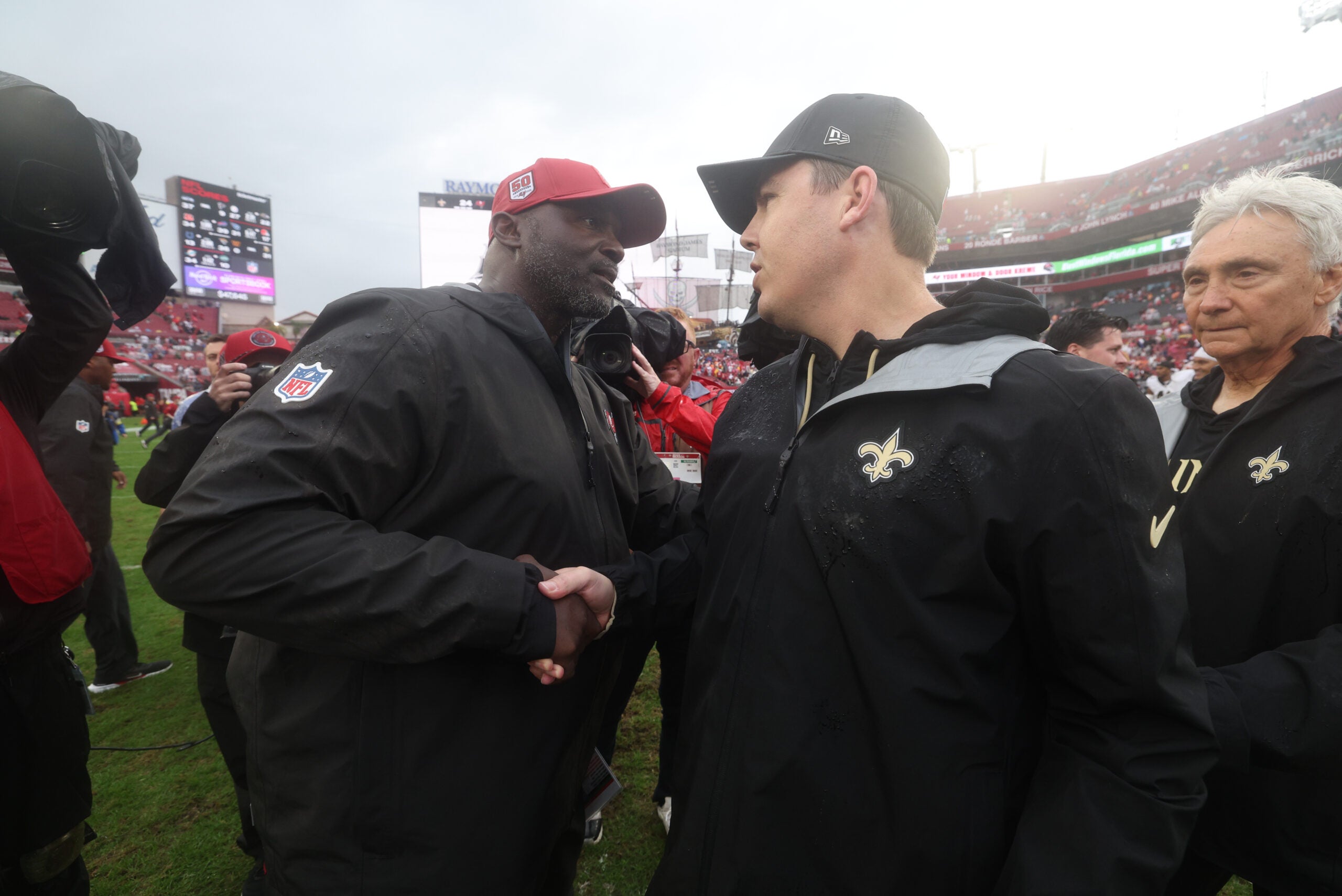 Dec 7, 2025; Tampa, Florida, USA; Tampa Bay Buccaneers head coach Todd Bowles shakes hands with New Orleans Saints head coach Kellen Moore following a game at Raymond James Stadium.