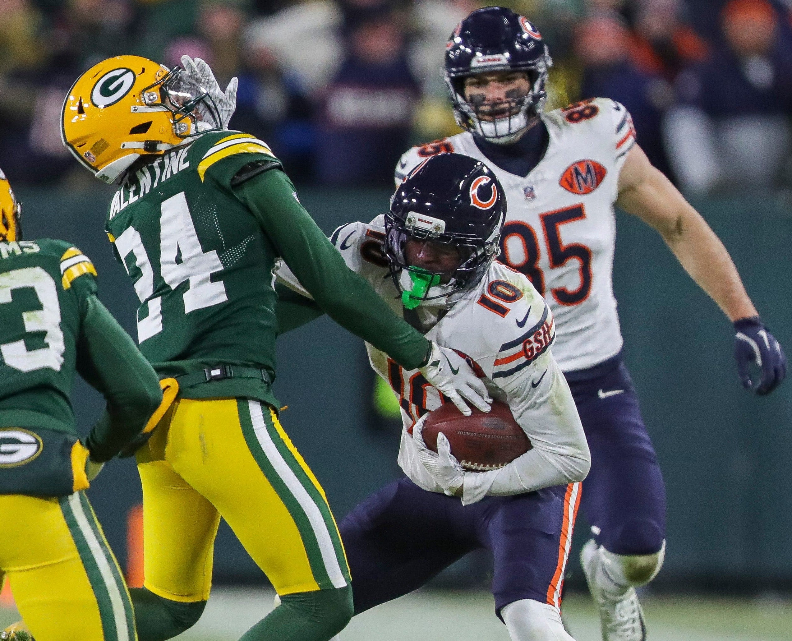 Chicago Bears wide receiver Luther Burden III (10) stiff-arms Green Bay Packers cornerback Carrington Valentine (24) on Sunday, December 7, 2025, at Lambeau Field in Green Bay, Wis.