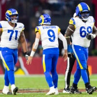 Dec 7, 2025; Glendale, Arizona, USA; Los Angeles Rams quarterback Matthew Stafford (9) celebrates a touchdown with offensive lineman Warren McClendon Jr. (71) and Kevin Dotson (69) against the Arizona Cardinals at State Farm Stadium.