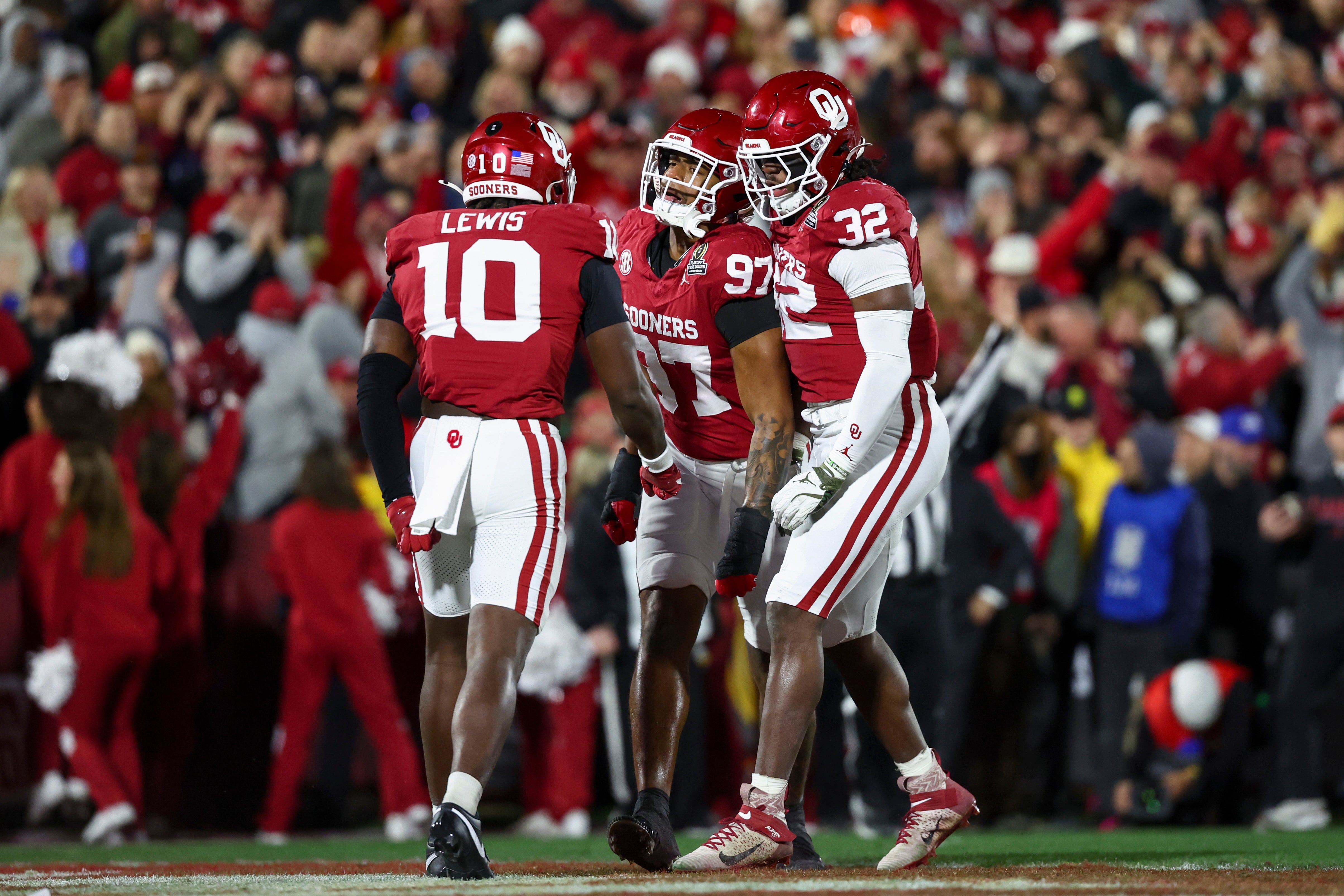 Dec 19, 2025; Norman, OK, USA; Oklahoma Sooners linebacker Kip Lewis (10), defensive lineman Marvin Jones Jr. (97) and defensive lineman R Mason Thomas (32) celebrate a tackle against the Alabama Crimson Tide in the first half at Gaylord Family OK Memorial Stadium.