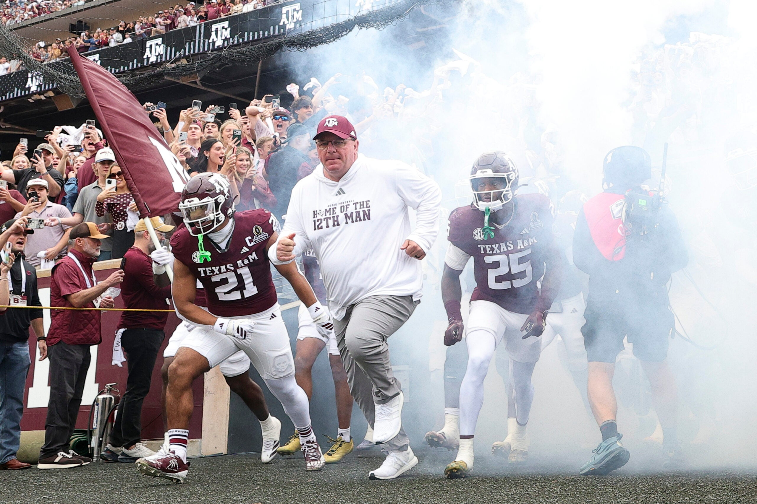 Dec 20, 2025; College Station, TX, USA; Texas A&M Aggies head coach Mike Elko takes the field prior to the game against the Miami Hurricanes during the first round of the CFP National Playoff at Kyle Field.