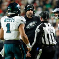 Dec 20, 2025; Landover, Maryland, USA; Philadelphia Eagles head coach Nick Sirianni talks with quarterback Jalen Hurts (1) and an official during the first half against the Washington Commanders at Northwest Stadium.