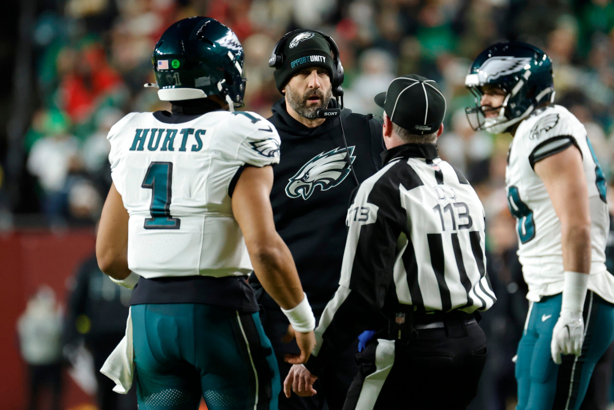 Dec 20, 2025; Landover, Maryland, USA; Philadelphia Eagles head coach Nick Sirianni talks with quarterback Jalen Hurts (1) and an official during the first half against the Washington Commanders at Northwest Stadium.