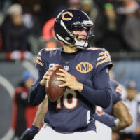 Dec 20, 2025; Chicago, Illinois, USA; Chicago Bears quarterback Caleb Williams (18) looks to throw a pass against the Green Bay Packers during the first quarter at Soldier Field.