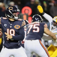 Dec 20, 2025; Chicago, Illinois, USA; Chicago Bears quarterback Caleb Williams (18) prepares to throw a pass and offensive tackle Ozzy Trapilo (75) blocks against Green Bay Packers defensive end Rashan Gary (52) during the first quarter at Soldier Field.