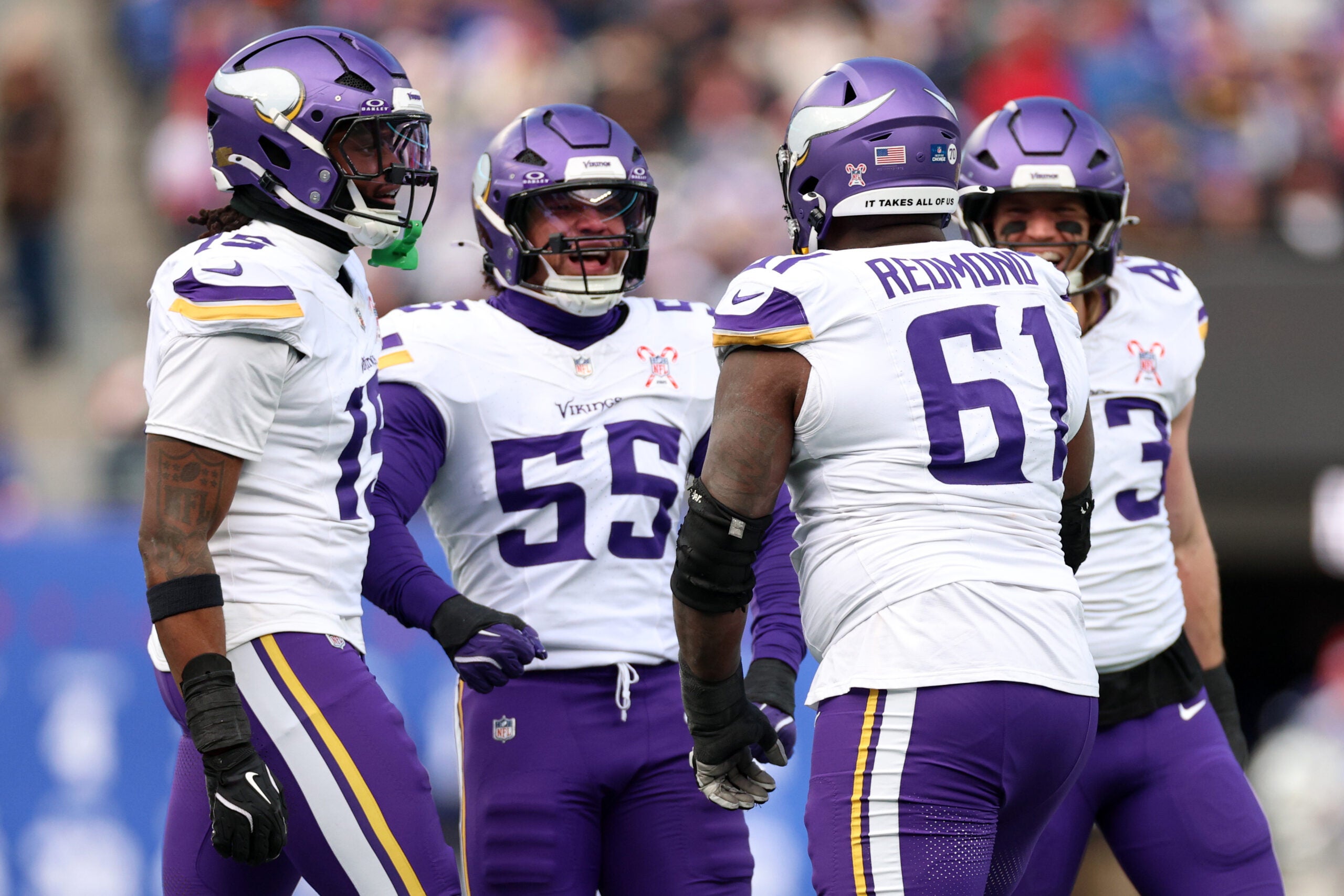 Dec 21, 2025; East Rutherford, New Jersey, USA; Minnesota Vikings defensive lineman Jalen Redmond (61) reacts with linebacker Eric Wilson (55) during the first half at MetLife Stadium.