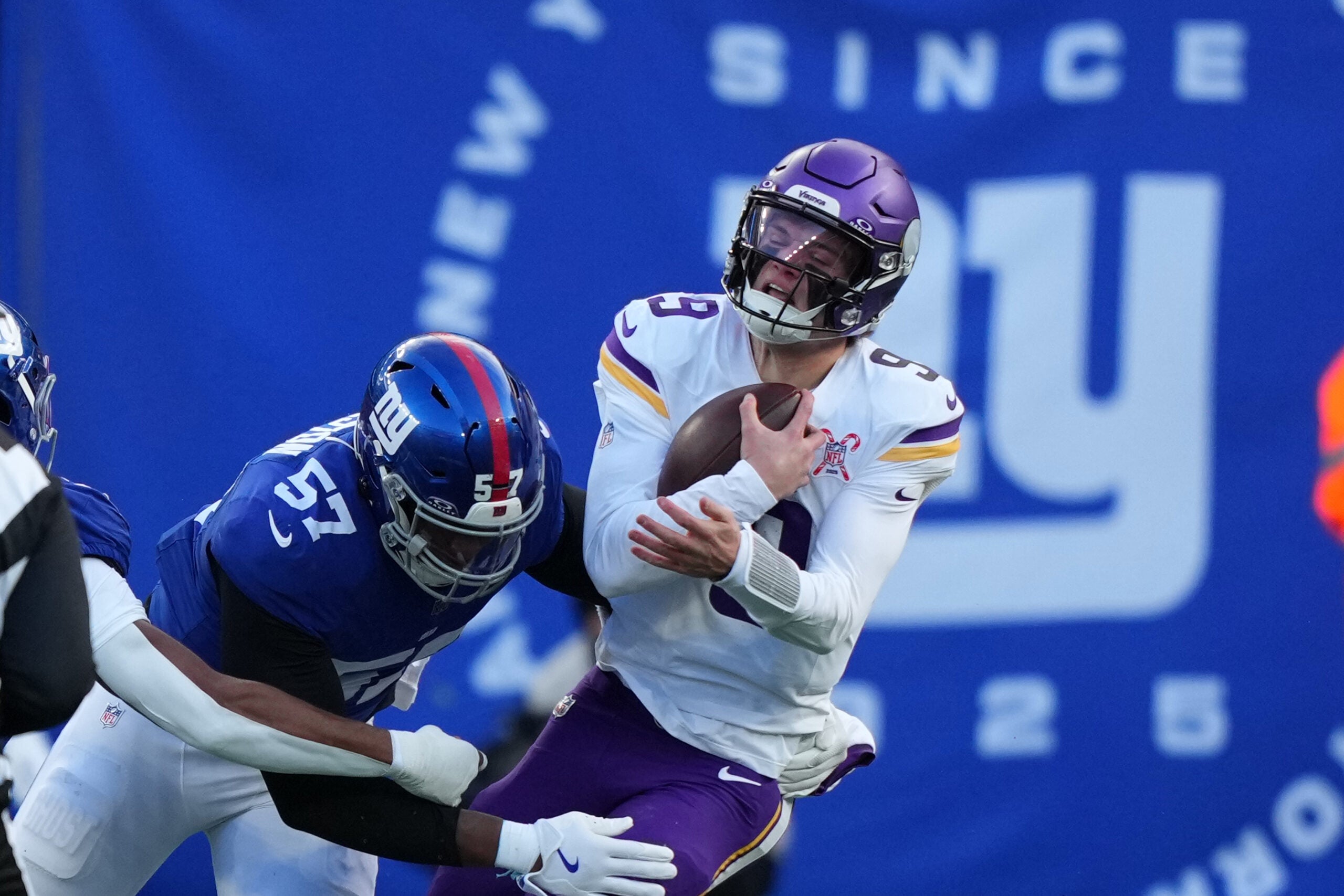 Dec 21, 2025; East Rutherford, New Jersey, USA; New York Giants defensive end Chauncey Golston (57) sacks Minnesota Vikings quarterback J.J. McCarthy (9) during the first half at MetLife Stadium.