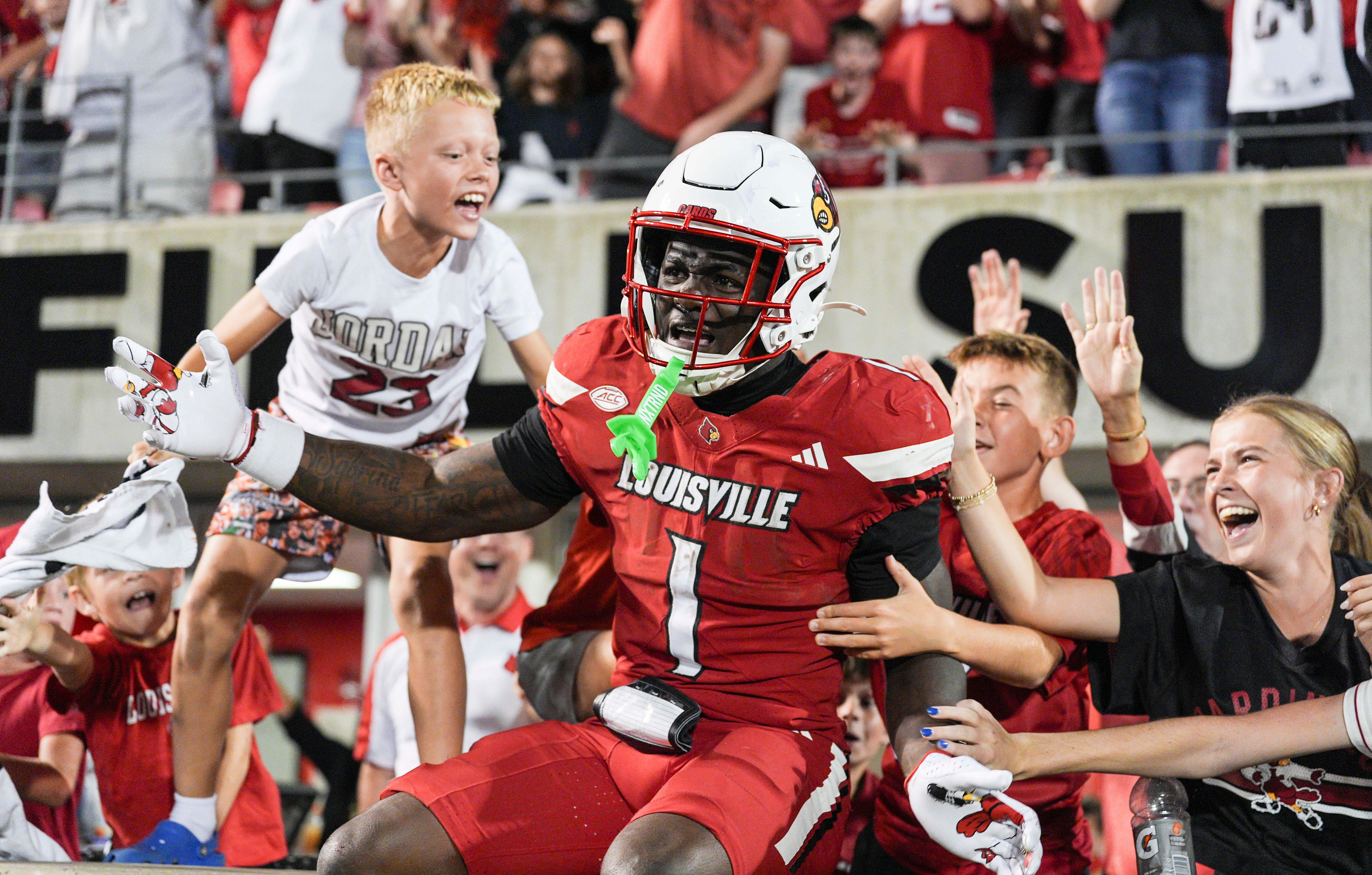 Louisville Cardinals running back Isaac Brown (1) celebrates with fans in the end zone after a big fourth quarter touchdown run against James Madison during the Cards' second college football game Friday September 5, 2025 at L&N Credit Union Stadium in Louisville, Kentucky.